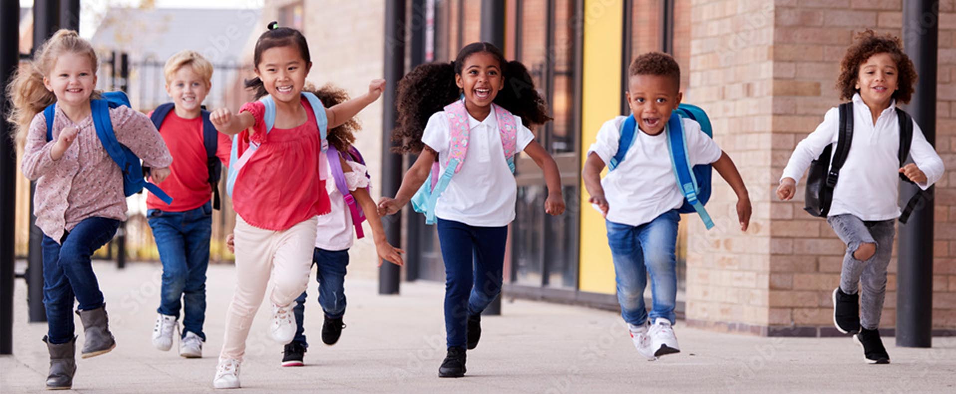 young elementary school children running and playing at school